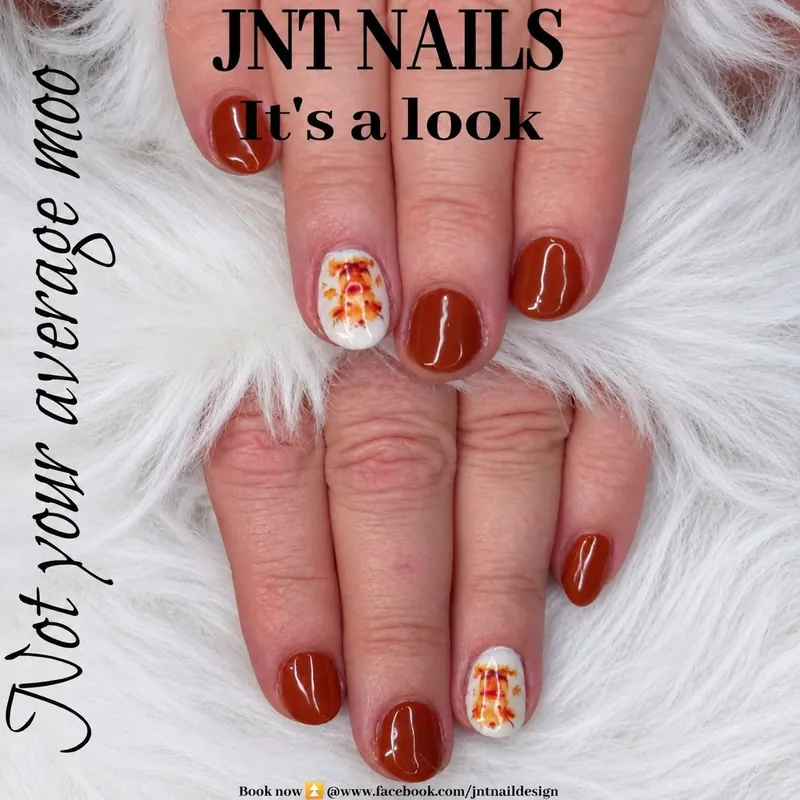 Glossy rust red nails with a cute cow feature nail, JNT Nails post